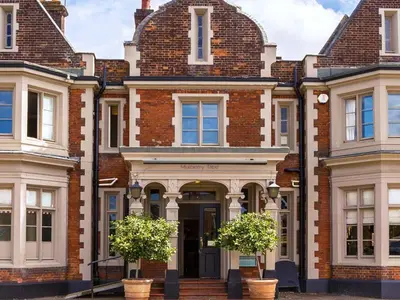 a large brick building with two trees in front of it at Mulberry Tree in Attleborough