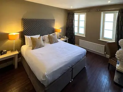 a bedroom with a large bed with white sheets and pillows at Mulberry Tree in Attleborough