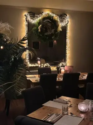 a dining room with tables and a large mirror at Mulberry Tree in Attleborough