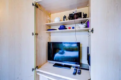 a tv sitting on a table in a room at Entire studio with private parking and balcony in Southend-on-Sea