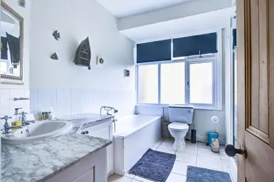 a bathroom with a tub and a toilet and a sink at Entire studio with private parking and balcony in Southend-on-Sea