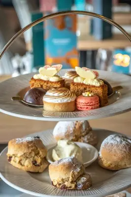 two tiered plates of pastries on a table at Wivenhoe House Hotel in Colchester