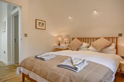 a bedroom with a bed with two towels on it at 2 Bed in Ketteringham oc-p27381 in East Carleton
