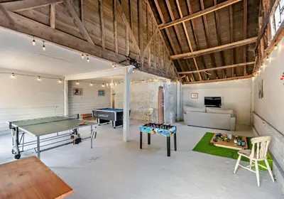 a room with a ping pong table and a couch at Luxury Silver Birch Lodge: Hot Tub/BBQ/Fire Pit in Toppesfield