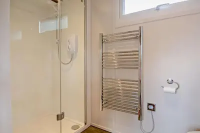 a shower with a glass door in a bathroom at 1 Bed in Chelmondiston oc-l29137 in Chelmondiston