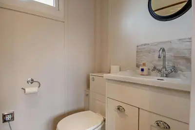 a bathroom with a toilet and a sink and a mirror at 1 Bed in Chelmondiston oc-l29137 in Chelmondiston