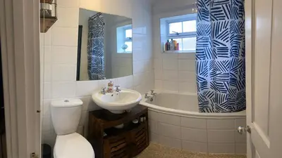 a bathroom with a toilet and a sink and a tub at relaxed and peaceful in St Ives