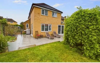 a brick house with a patio and a yard at relaxed and peaceful in St Ives
