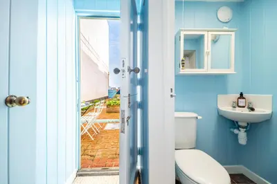 a bathroom with a toilet and a sink at Marine Cottage in Aldeburgh