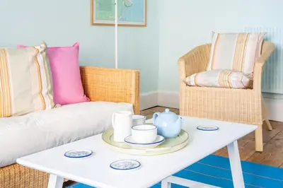 a living room with a white coffee table and a couch at Marine Cottage in Aldeburgh