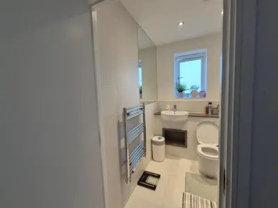 a bathroom with a toilet and a sink and a mirror at Double Room in a shared 4 bedroom family home in Broomfield in Chelmsford