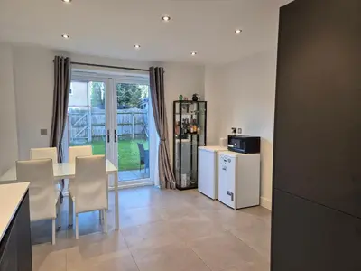 a kitchen and dining room with a table and chairs at Double Room in a shared 4 bedroom family home in Broomfield in Chelmsford