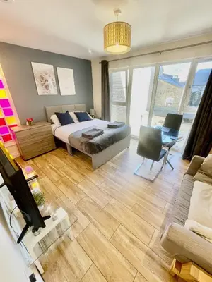 a bedroom with a bed and a living room at 1 Bed Studio - Sleeps 2 - Parking - Wifi in Cambridge