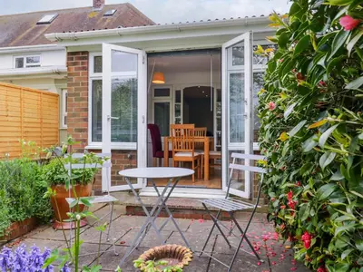 a house with a door open to a patio at The Annex in Colchester