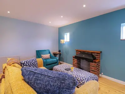 a living room with a couch and a fireplace at The Annex in Colchester