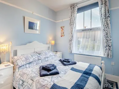a bedroom with a bed with two towels on it at Beachcombers Retreat in Felixstowe