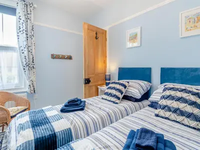 two beds sitting next to each other in a bedroom at Beachcombers Retreat in Felixstowe