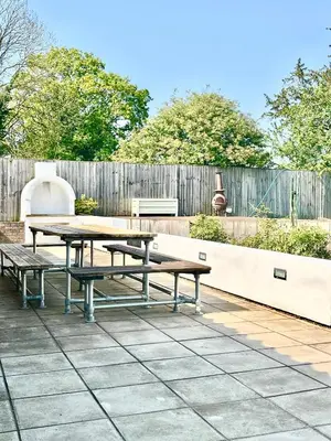 a picnic table and benches on a patio at Oak Grange holiday cottage in Hoxne