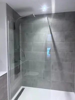 a shower with a glass door in a bathroom at The Ivy Abode 2 bedroom Apartment in Harlow
