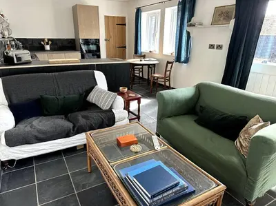 a living room with two couches and a table at Mersea best kept secret in Colchester