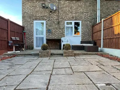 a patio in front of a brick building at Lovely 3 bedroom house near city centre - Basildon in Basildon