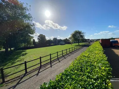 a row of bushes next to a fence at Willow Shepherd Hut in West Row