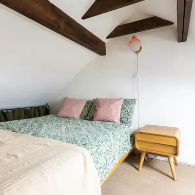 En-suite with double bed on mezzanine and desk in family home