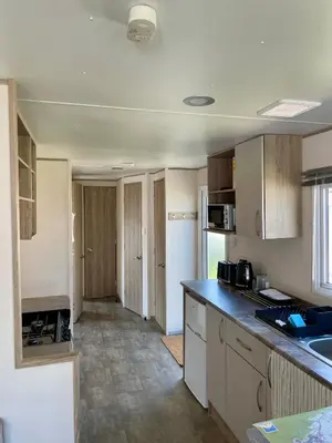 a kitchen with a sink and a counter top at Caravan at Seawick Holiday Park Close to Beach in Saint Osyth