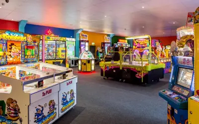 a room filled with lots of arcade games at Caravan at Seawick Holiday Park Close to Beach in Saint Osyth