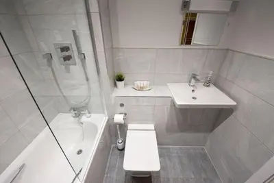 a bathroom with a toilet and a sink and a shower at Modern,Bright and spacious 2 bed in Brentwood