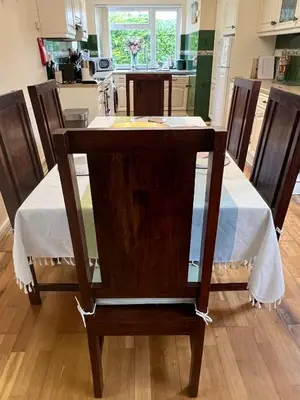 a table with a white table cloth on it in a kitchen at Cozy 3 bedroom bungalow in rural location in Ashwell