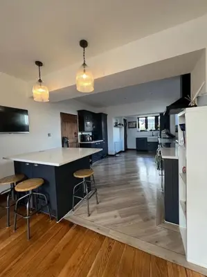 a kitchen with a counter and stools in a room at Home by the Sea in Clacton-on-Sea