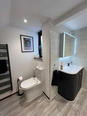 a bathroom with a white toilet and a sink at Home by the Sea in Clacton-on-Sea