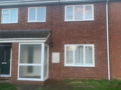 a brick house with white windows and a door at Contractors and families welcome in Earith