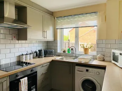 a kitchen with a sink and a washing machine at Contractors and families welcome in Earith