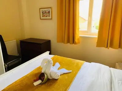 a room with a bed with towels on it at Contractors and families welcome in Earith