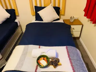 a bedroom with a bed with a bowl of food on it at Contractors and families welcome in Earith