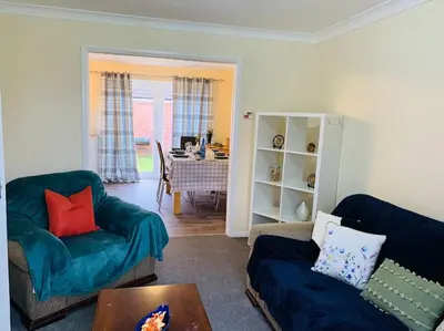 a living room with a couch and a table at Contractors and families welcome in Earith