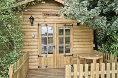 a wooden cabin with a wooden door and a bench at Inviting 1-Bed Cabin in Newmarket in Newmarket