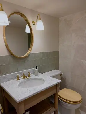 a bathroom with a sink and a toilet and a mirror at Willow Barn, Long Melford in Long Melford