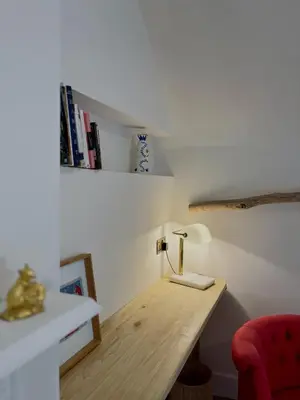 a room with a desk with a lamp and books at Willow Barn, Long Melford in Long Melford