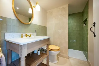 a bathroom with a sink and a toilet and a mirror at Willow Barn, Long Melford in Long Melford