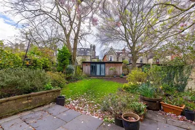 a garden with a house in the background at Pass the Keys Spacious Victorian Home with Free Parking in Cambridge