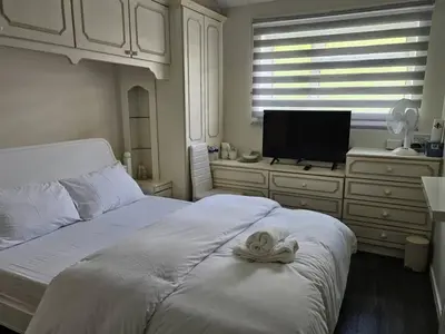 a bedroom with a bed with a towel on it at Jays-Rooms in Pitsea