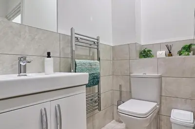 a white bathroom with a toilet and a sink at Chelmsford City Central Ground Floor Apartment Next To Town Centre in Chelmsford