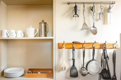 a kitchen with utensils hanging on a wall at Kestrel - Sweffling Hall in Rendham