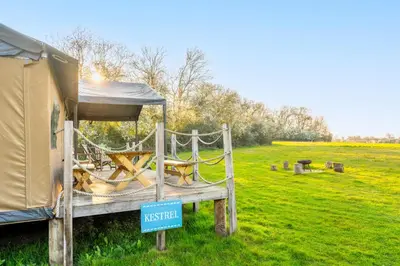 a tent and a sign in front of a field at Kestrel - Sweffling Hall in Rendham