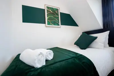 a bedroom with a bed with a towel on it at Yew Tree Close Mildenhall Bury St Edmunds in Mildenhall