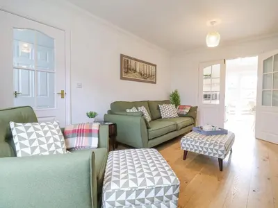 a living room with two couches and a table at 23 Church Farm Lane in Halesworth