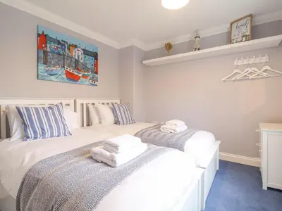 two twin beds in a bedroom with white at 23 Church Farm Lane in Halesworth